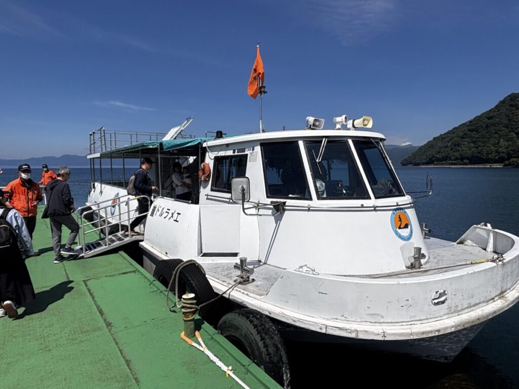北海道・支笏湖の遊覧船に乗り込む人々と船の外観